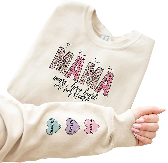 Personalized This Mama Wears Her Heart On Her Sleeve Sweatshirt, Custom Valentines Day Mama Sweatshirt With Kids Name On Sleeve